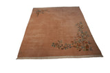 Angled view of vintage Japanese Art Deco rug, dusty rose plush pile, and sprawling floral vines.