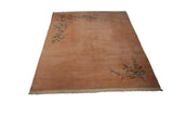 Dusty rose Japanese Art Deco vintage carpet with ornate floral vines across opposing corners.