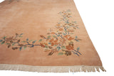 Secure off-white fringe and corner foliage of the dusty rose Art Deco rug.