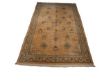 Angled shot of a vintage Japanese Peking carpet revealing its floral medallions and intricate T-border.