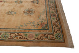 Corner of a vintage Peking carpet showing the meandering vine border and powder blue T-motif.