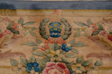 Japanese Savonnerie rug weaver insignia, blue wreath, pink rose bouquets, beige field.