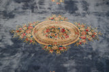 Ornate rose bouquets and medallion border on the pale denim blue Japanese Savonnerie carpet.