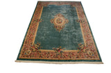 Floral vinery and rose bouquets on the mauve border of this Japanese Savonnerie rug.