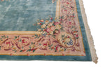 Ornate main border of a Japanese Savonnerie rug with scrolling vinery and rose bouquets.