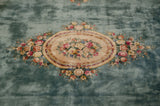 Ivory cameo medallion with rose, mauve, cochineal floral bouquets on a Japanese Savonnerie rug.