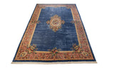 Angled view of Japanese Savonnerie rug: sky blue field, rose medallion, scrolling floral borders.