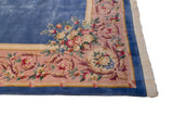Intricate Savonnerie border with rose bouquets, scrolling vinery on pink, sky blue, and fringe.