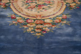 Sky blue field transitions to dense floral rose bouquets on a Savonnerie carpet.