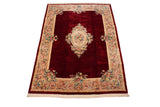 Vintage hand-knotted Japanese Savonnerie carpet with deep red field and ivory floral medallion, 10'x14'.