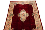 Hand knotted Japanese Savonnerie rug, black cherry red field with a floral medallion.
