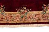 Japanese Savonnerie rug border with scrolling vinery, pastel rose bouquets, and ivory fringe.
