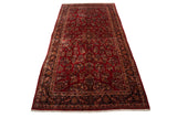 Vintage Sarouk carpet with allover floral bouquets on a cherry red field and an intricate dark navy border.
