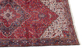 Stepped medallion and ivory spandrel corner on a vintage Persian Mehrivan carpet with a navy border.