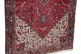 Intricate geometric border and clean white fringe on the corner of a vintage Persian Mehrivan carpet.
