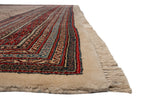 Corner view of vintage Mir Sarouk rug, with ivory border, red and blue patterns, and fringe.