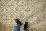 Diamond lattice floral bouquets on an ivory Agra rug with dusty green Herati border.