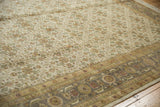 Agra carpet's ivory field with dusty gold, green florals and darker, oxidized Herati border.