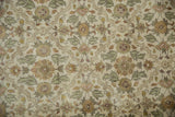 Close-up of vintage Agra carpet's even pile, featuring dusty ivory, green, gold floral bouquets.