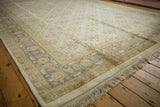 Agra carpet corner, showcasing its ivory fringe, clean selvage, and dusty green Herati border.