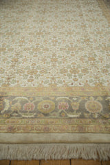 Agra carpet's detailed Herati border, oxidized silver, dusty green, and cochineal red motifs.