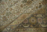 Agra carpet detail: folded pile, ivory, dusty green, gold floral patterns, main border.