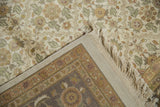 Agra carpet corner with dusty gold and cochineal red Herati border, and fringed edge.