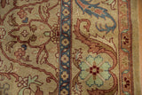 The scrolling leaf and palmette border of a vintage Indian carpet in lustrous, full wool pile.