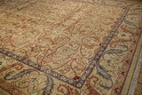 Close view of the plush, hand-knotted wool showing the carpet's scrolling palmette border design.