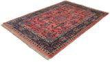 Lustrous ruby red field of a vintage Indian Sarouk carpet with navy paisley borders.