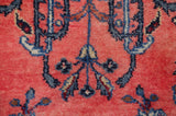 Vibrant ruby red field with ornate navy blue and beige vinery of the Indian rug.