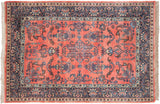 Corner detail of vintage Sarouk rug with ruby red field, navy border, and boteh paisley.