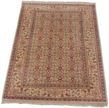 Angled view of a vintage Mahal carpet with an allover Herati motif on a beige field.