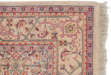 Corner detail of a vintage Indian Mahal rug showing the plush wool, Herati motif, and original side fringe.