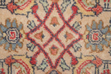 Close-up of the Herati motif in red, blue, and yellow on a dense, hand-knotted wool pile.