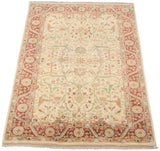 Hand-knotted Indian Bijar carpet corner: terra cotta floral border, ivory arabesques, and fringe.