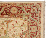 Ivory field, terra cotta, celadon floral arabesques of a vintage Indian Bijar rug corner with fringe.