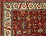 Corner view of the Heriz carpet's ivory border with serrated leaves and geometric floral motifs.