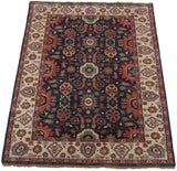 Corner view of vintage Indian Sultanabad design carpet with dusty navy floral field and ivory border.
