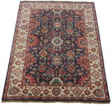 Hand-knotted Indian Sultanabad design carpet corner, with navy field, floral arabesques, ivory border, and fringe.