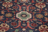 Indian Sultanabad carpet showing floral arabesques, vinery, and blossoms in navy, blush, celadon.