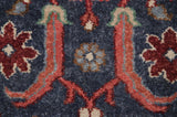 Close-up of hand-knotted Indian Sultanabad design with vibrant floral arabesques on navy.