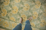 Embossed floral Arts and Crafts pattern with saffron palmettes and sea foam green.