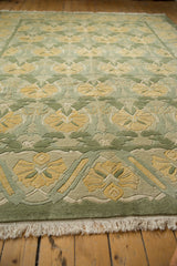Embossed floral palmette pattern with carved relief in sea foam green, saffron yellow, and fringe.