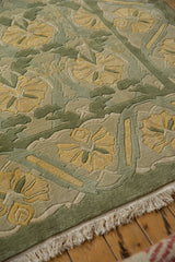 Wide sea foam green border, plush carved floral texture, pale fringe on Arts and Crafts rug.