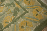 Textured embossed floral palmettes in sea foam green and saffron on Indian Arts and Crafts rug.