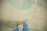 Softly distressed texture of a vintage Bulgarian rug showing its sky blue and ivory pattern.