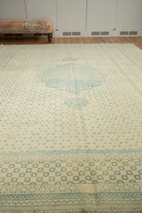 Angled view of a vintage Bulgarian Tabriz carpet showing the uninterrupted blue lattice pattern and central medallion.