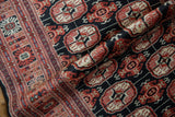 Lustrous wool pile and fine weave of a vintage Bokhara rug with repeating gul medallions.