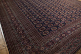 Angled view of the lustrous pile on a vintage Bokhara carpet with navy and red gul medallions.